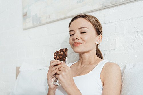 happy woman eating chocolate